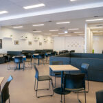 Large and spacious classroom with tables, chairs and couches at the Y School
