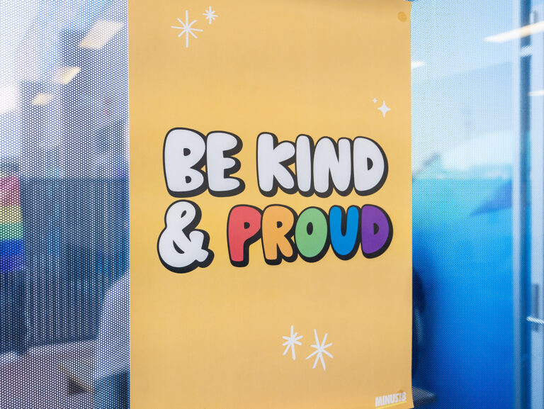 Close up of 'Be kind & proud' sign on the door at the Y School Mirrabooka campus