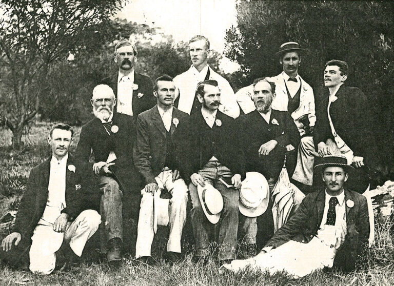 Vintage black and white group photo of the first YMCA Board of Perth members in Victorian-era formal attire.
