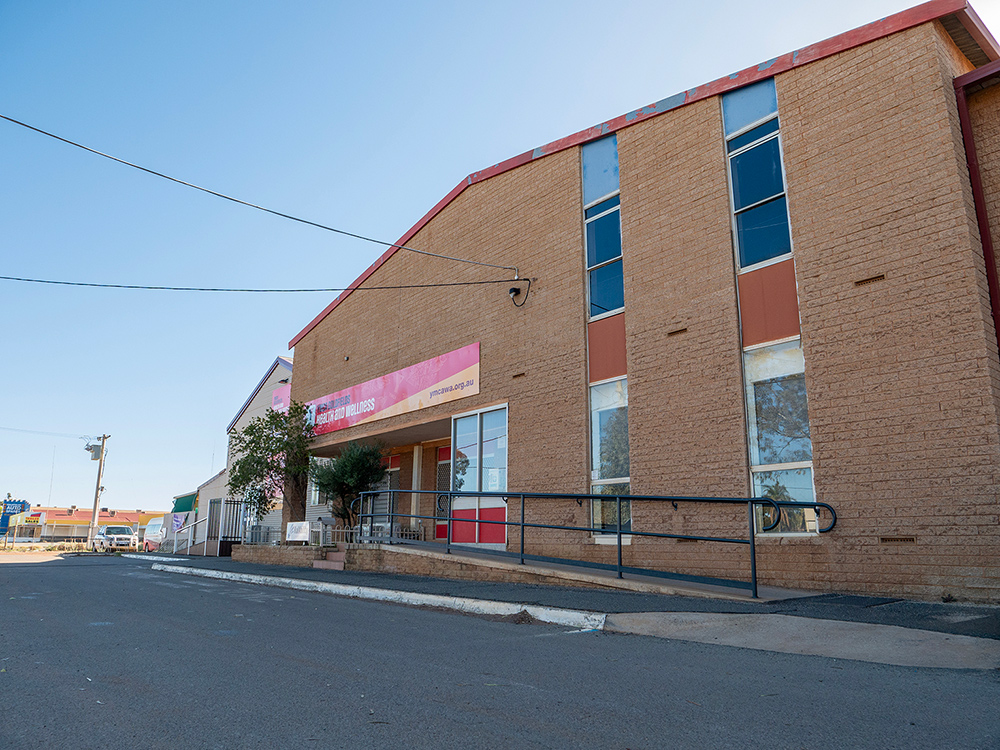 Exterior of the Y Kalgoorlie Recreation Centre with a bold red and yellow sign on the building