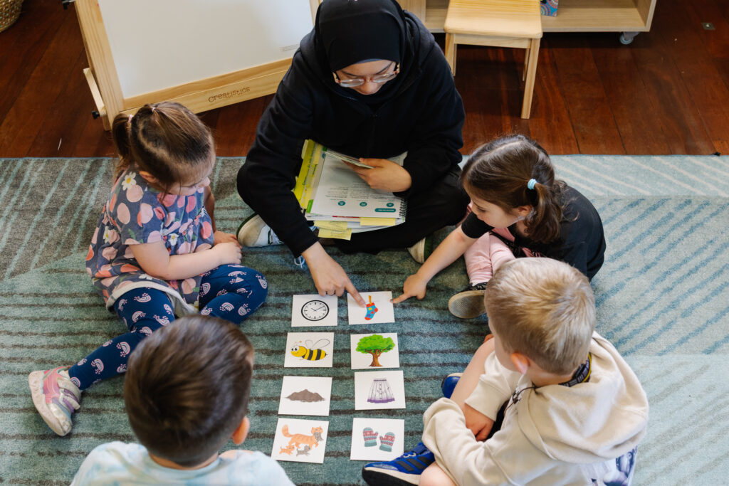 Educator and four children engaging with an early learning activity as part of the Y WA School ReadY Program at their Early Learning Centre.