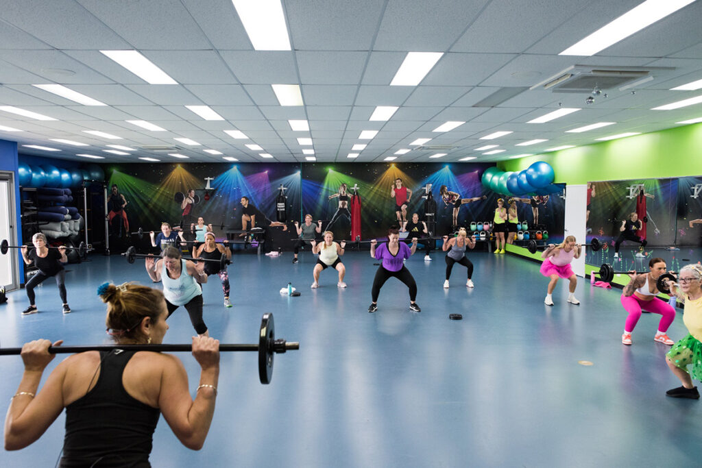 Group fitness class underway in spacious room at a rec centre