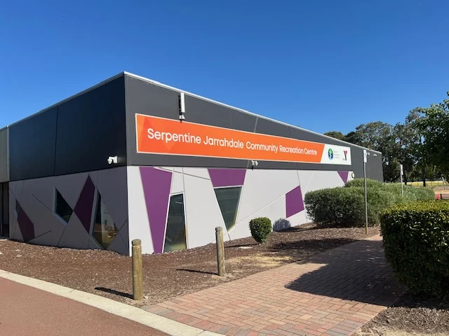 Front of serpentine jarrahdale community recreation centre with signage and plants showing