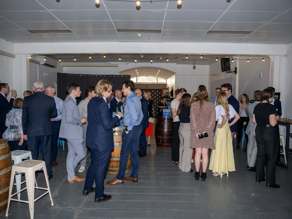 Room full of people networking at the 30th Youth Parliament anniversary alumni event
